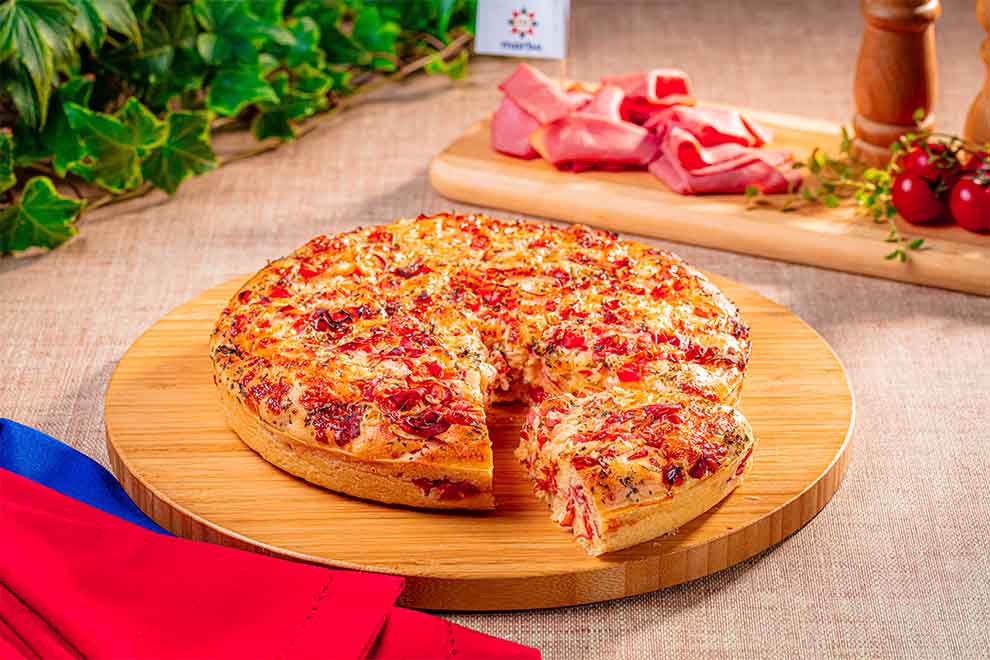 Você já pensou em usar mortadela de maneiras diferentes na cozinha? Além de ser uma escolha clássica para lanches e tábuas de frios, ela é um ingrediente que pode combinar com receitas como tortas salgadas e outros assados. É fácil de manusear, saborosa e surpreendentemente versátil.

Explore várias ideias para inovar no cardápio com receitas fáceis e deliciosas que toda a família vai adorar. E sabe o que faz toda a diferença? Usar produtos de qualidade, como a Mortadela Marba, que deixa tudo ainda mais gostoso. Continue lendo e confira nossas sugestões!

1. Pizza de mortadela de liquidificador



A pizza de liquidificador com mortadela é perfeita para quem busca uma receita prática e cheia de sabor. A massa é feita no liquidificador com ingredientes simples, como farinha, leite e ovos. O recheio leva mortadela em fatias, molho de tomate e queijo, criando uma combinação irresistível.

Essa receita é ideal para jantares rápidos ou como petisco em uma reunião com amigos. Além disso, é super versátil: você pode adicionar ervas ou outros queijos para incrementar ainda mais o sabor.



#DicaDoMinhaReceita: se quiser deixar a receita ainda mais especial, você pode variar os ingredientes do recheio. Adicione cebolas caramelizadas, tomates-cereja ou até ervas frescas, como manjericão, para trazer um toque extra de aroma.







2. Torta de liquidificador com mortadela

Se você quer uma opção clássica de torta salgada, essa receita é a escolha certa! A massa é leve e macia, preparada com ingredientes básicos. O recheio combina mortadela, queijo e temperos, resultando em um prato que pode ser servido no almoço, no jantar ou até no lanche da tarde.

É uma excelente opção para quem precisa de praticidade e quer aproveitar as sobras de ingredientes da geladeira. Experimente adicionar tomate em cubos ou azeitonas para dar um toque especial.







3. Rocambole salgado de mortadela italiana com azeitonas



O rocambole salgado de mortadela italiana com azeitonas é aquele prato que une sofisticação e sabor em uma única receita. Feito com uma massa macia e fácil de trabalhar, ele é recheado com camadas de mortadela italiana com azeitonas Marba picadas e queijo, criando uma combinação irresistível de sabores e texturas.

Essa é uma opção incrível para quem quer sair da rotina e preparar algo diferente, seja para um almoço de domingo ou para um jantar mais especial. O recheio pode ser incrementado com ervas frescas, como orégano ou tomilho, ou até mesmo pimentões coloridos para um toque extra de cor e sabor.

Também é uma ótima ideia fatiá-lo em porções menores para servir como entrada em uma reunião com amigos. É um prato que impressiona tanto pela apresentação quanto pelo sabor!







4. Pão caseiro de mortadela Marba

Que tal um pão caseiro recheado com mortadela? Essa receita une o aroma irresistível do pão fresquinho com o sabor marcante da mortadela defumada Marba Royal. A massa é fofinha e o recheio pode ser incrementado com ervas e queijos.

Além de ser um ótimo lanche, esse pão é perfeito para um café da tarde ou para levar em um piquenique. Experimente tostar as fatias antes de servir para realçar ainda mais os sabores!







5. Mini pizza enrolada de mortadela

As mini pizzas enroladas são perfeitas para quem busca praticidade e criatividade. A massa é enrolada como um rocambole, com recheio de mortadela e molho de tomate.

Essa receita é ótima para lanche em festas infantis ou como lanche rápido para o dia a dia. Você também pode variar os recheios, adicionando queijo para um toque especial.







6. Quiche de mortadela e queijo fresco

Uma quiche é sempre uma opção sofisticada, e essa versão com mortadela e queijo fresco é irresistível. A base é feita com uma massa leve, e o recheio combina a cremosidade do queijo com o sabor inconfundível da mortadela.

Essa receita é ideal para um brunch ou como entrada em um jantar especial. Experimente servir com um vinho branco suave para uma experiência ainda mais refinada.







7. Empadinha de mortadela

As empadinhas de mortadela são perfeitas para festas ou para levar como lanche. A massa é leve e desmancha na boca, enquanto o recheio de mortadela defumada traz sabor e um toque de nostalgia.

Elas são uma ótima opção para substituir salgados tradicionais em eventos. Você pode preparar uma versão maior para servir como prato principal, acompanhada de uma salada!







Por que a mortadela é ótima para recheios de tortas e assados?

A mortadela é um ingrediente que combina sabor muito característico, com uma textura macia e muita versatilidade para testar em várias receitas diferentes.

Ela se adapta bem a diferentes tipos de massas, como tortas, pães e quiches, agregando um toque especial às preparações. Além disso, o custo-benefício e a facilidade de uso tornam esse embutido uma escolha inteligente para quem busca praticidade e sabor na cozinha.

E quando falamos de qualidade, a Mortadela Marba é referência. Produzida com tradição e cuidado, ela oferece sabor equilibrado e textura ideal, elevando qualquer receita a outro nível.

Gostou das sugestões? Então, aproveite para conferir nosso artigo com 6 ideias de petiscos com mortadela que ficam deliciosos. Continue explorando o site do Minha Receita e descubra ainda mais inspirações para a sua cozinha!