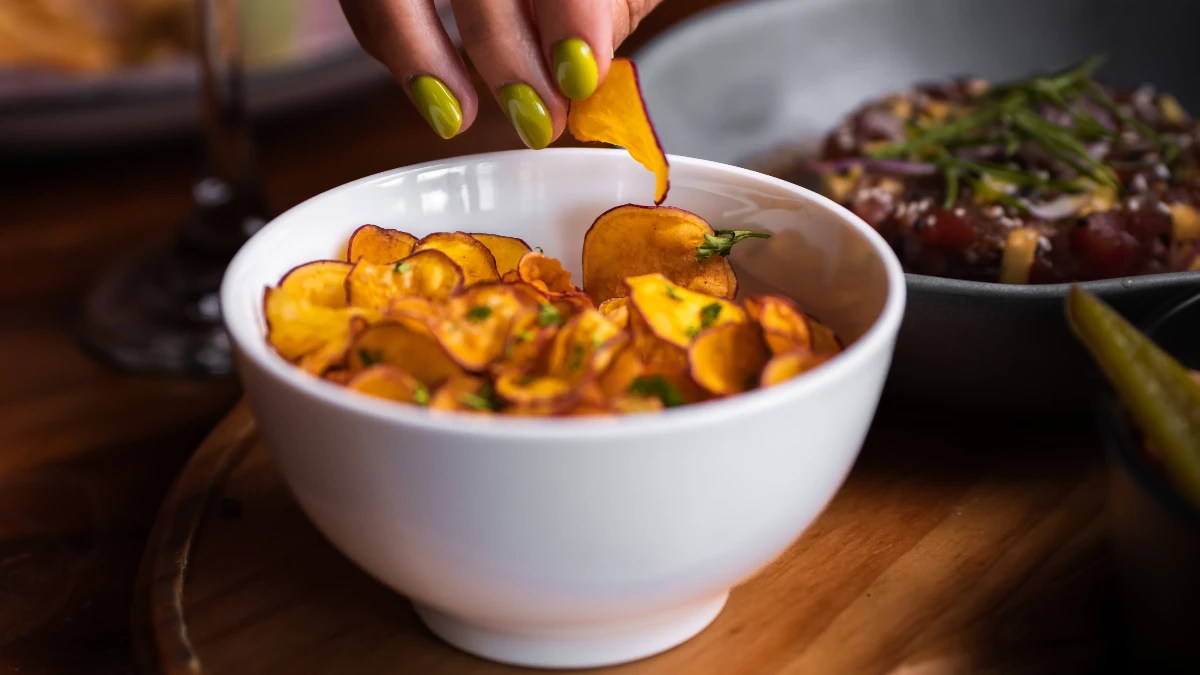 Chips de batata doce na airfryer servido em uma tigela branca.